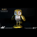 A collectible owl figurine from Star Ace's Bubo Vintage-Stylized Series, featuring a metallic gold and silver body with red star-patterned eyes, standing on a gold base against a black background.