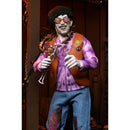 Action figure with a tie-dye shirt, blue pants, and glasses in a decorative setting.