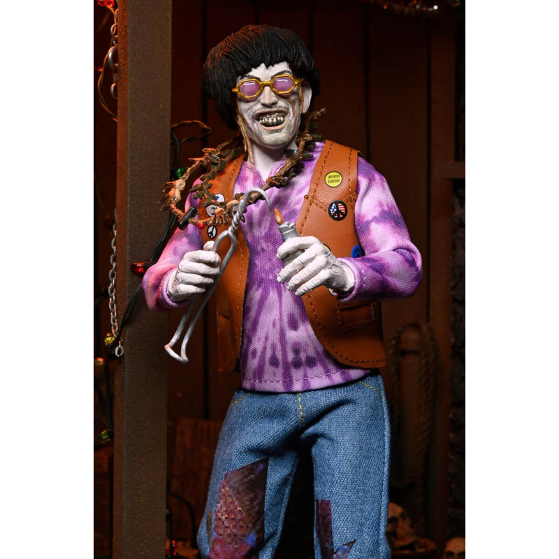 Action figure with a tie-dye shirt, blue pants, and glasses in a decorative setting.
