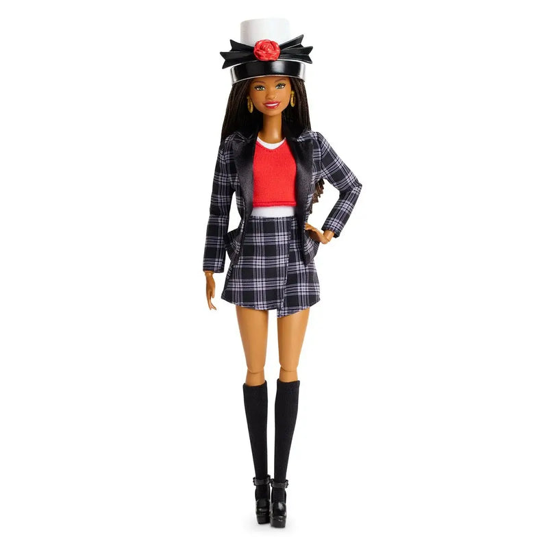 Barbie doll in a plaid outfit with a red top and black hat on a white background