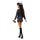 Barbie doll in a plaid outfit with a hat on a white background