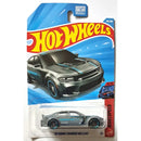Hot Wheels 2020 Dodge Charger Hellcat die-cast toy car in its original blister card packaging, featuring a gray car with blue stripes on a blue and yellow card.