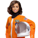 Doll in an orange astronaut suit with a helmet on a white background