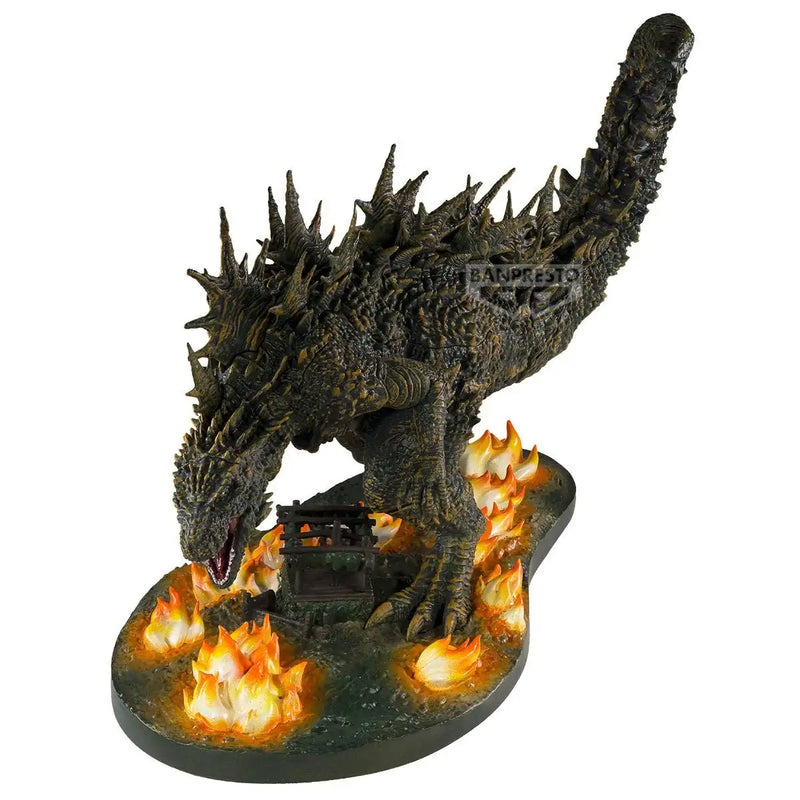Godzilla monster like figurine with flames on a white background