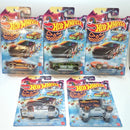 Five Hot Wheels toy cars in their original blister packaging, arranged on a white background. The set features various models with Halloween-themed graphics, including jack-o'-lanterns, ghosts, and pumpkins.