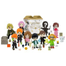 Collection of Harry Potter-themed figurines with a box in the background