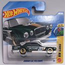 Hot Wheels die-cast toy car of the Jaguar XJC V12 Coupé, featuring a dark green and white race car with gold wheels, mounted on its original blue and yellow blister card packaging.