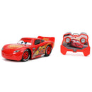 Red toy car with a remote control on a white background