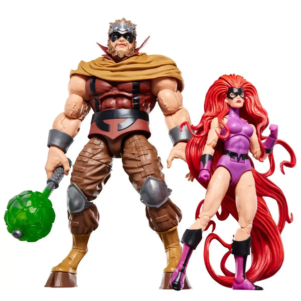 Two action figures, one with a green weapon and brown outfit, the other with red hair and purple outfit, on a white background.