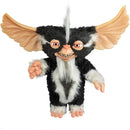Plush toy resembling a character with black and white fur, orange wings, and pinkish skin on a white background