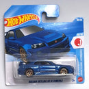 Hot Wheels Mattel Nissan Skyline GT-R (BNR34) die-cast toy car in its original blister pack packaging, featuring a blue car with gold wheels on a blue and white card.