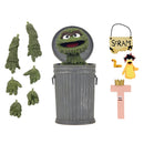 A Sesame Street Oscar the Grouch action figure set shown with a gray trash can, a yellow duck, a pink letter T with a crown, and a small sign reading SCRAM, all on a plain white background.