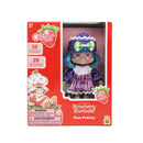 Toy figure of Strawberry Shortcake's Plum Pudding in its original red packaging box, featuring blue hair, a purple and white outfit, and a green bow.
