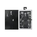 Vincent Price Action figure in a suit with packaging displaying multiple views