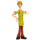 Toy figure of a character in a green shirt and red pants on a white background