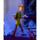 A Shaggy Scooby-doo action figure posed with arms outstretched, wearing a green shirt and red pants, set against a smoky blue and dark background with a chair in the foreground.
