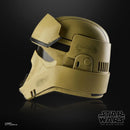 Tan helmet with black visor on a reflective surface, Star Wars logo visible