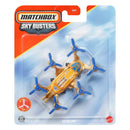 Matchbox Sky Busters Skyclone toy drone in its original blister card packaging. The toy is gold with blue propellers and a blue window on top, set against a blue sky graphic background on the card.