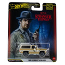 Hot Wheels Adventures Stranger Things 1985 Chevrolet K5 Blazer toy car in its original blister card packaging, featuring a beige and white vehicle with 'POLICE' markings.