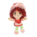 Plush toy resembling a character with red hair and a strawberry-themed outfit on a white background