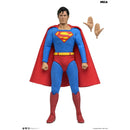 NECA Superhero Superman action figure with a red cape, blue suit, and red boots, shown standing against a white background with two detachable hands.