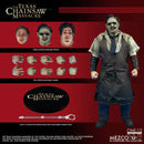 Action figure from 'The Texas Chainsaw Massacre' with interchangeable parts on a red background, featuring Mezco Toyz branding.