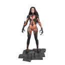 A detailed collectible action figure of a female vampire character with long dark hair, wearing a metallic copper and black insect-like bodysuit, standing on a dark gray stone base against a plain white background.