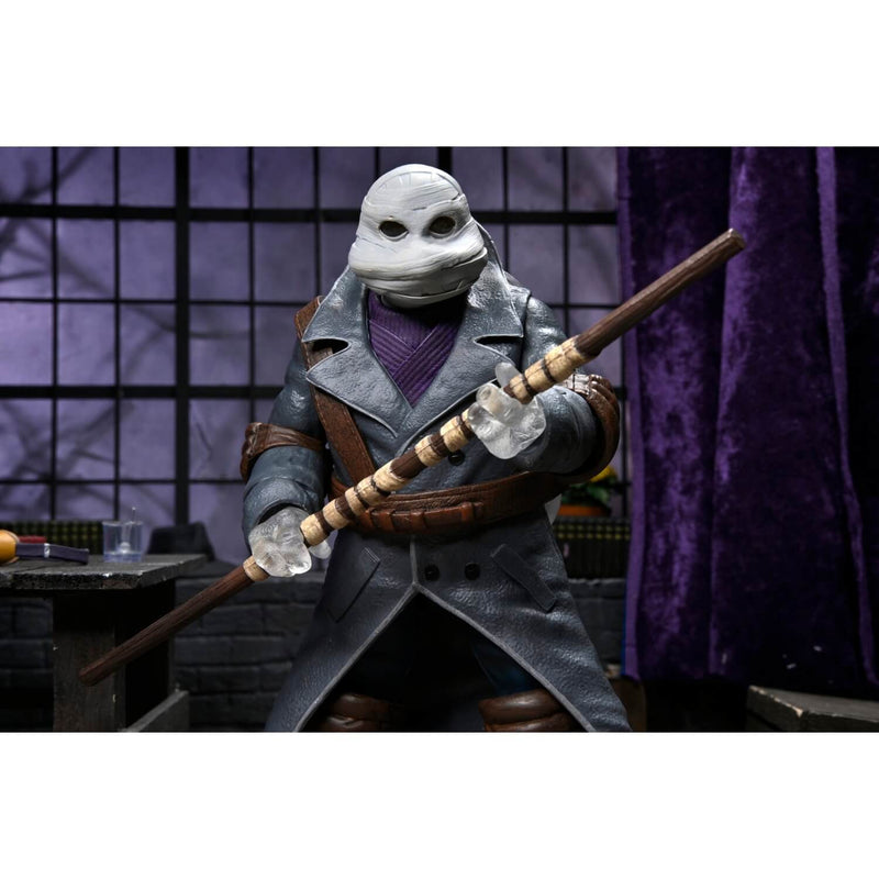 NECA Universal Monsters x Teenage Mutant Ninja Turtles Ultimate Donatello as The Invisible Man 7″ Scale Action Figure, holding bo staff in battle stance.