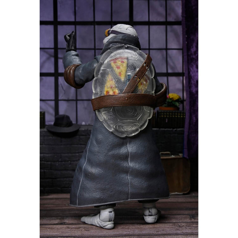 NECA Universal Monsters x Teenage Mutant Ninja Turtles Ultimate Donatello as The Invisible Man 7″ Scale Action Figure, back view showing "invisible" turtle shell with pizza hidden inside.