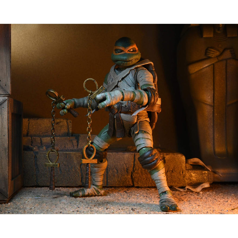 NECA Teenage Mutant Ninja Turtles Michelangelo as The Mummy 7” Scale Action Figure holding ankh nunchucks